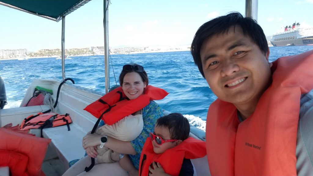 Family in a glass-bottom boat in Los Cabos- Cabo with kids
