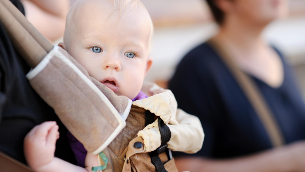 Baby being worn in a baby carrier