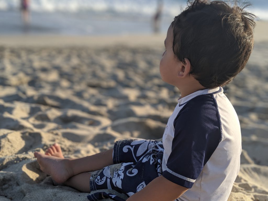 Boy sitting on the beach