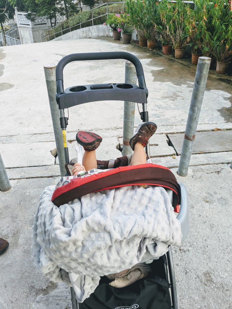 A baby in a stroller at Kek Lok Si Temple in Penang, Malaysia