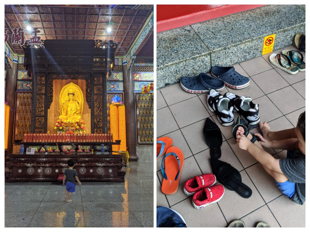 A boy removing his shoes outside a temple at Kek Lok Si Temple in Penang, Malaysia