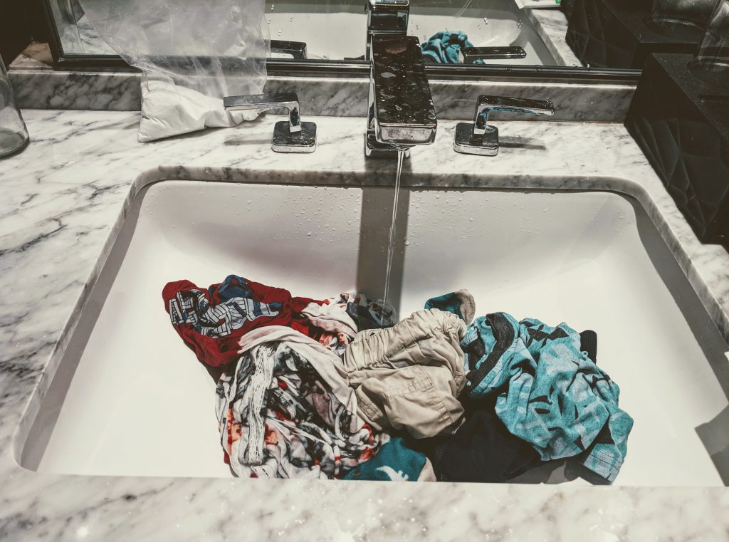 Traveling light by washing clothes in the sink in Italy