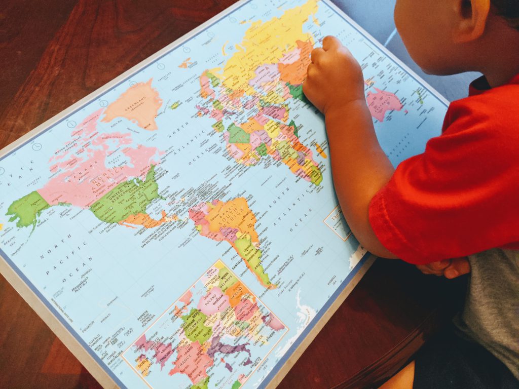 Boy finding Japan on a world map