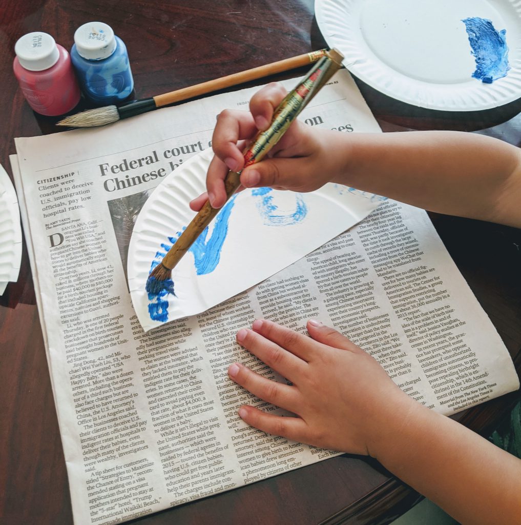 Painting a fan for our Japan preschool unit