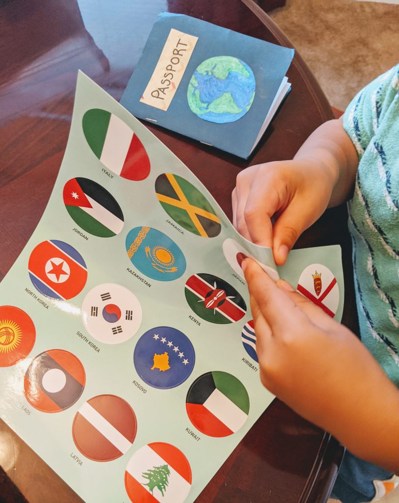 Boy putting a Japanese flag sticker in his paper passport