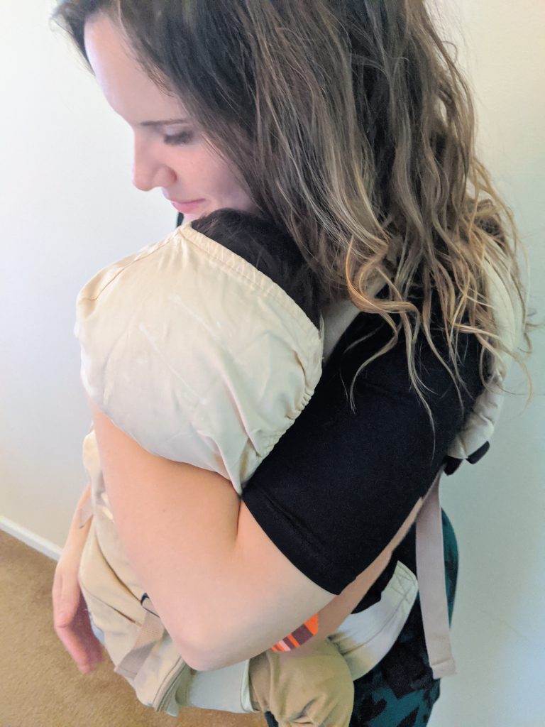 Put your arm under the baby's head in the carrier to support the baby while nursing
