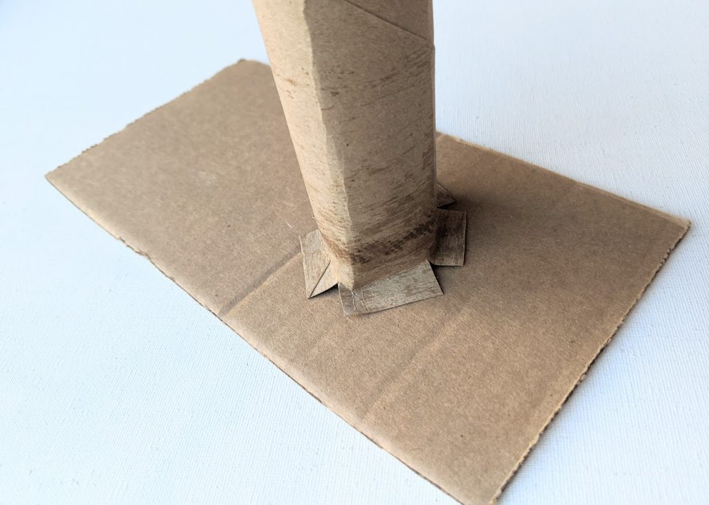 Base of paper towel roll glued to cardboard