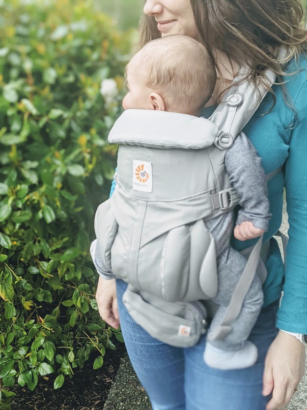 Baby in an Ergobaby Omni 360 carrier- a carrier is one of our top baby travel essentials