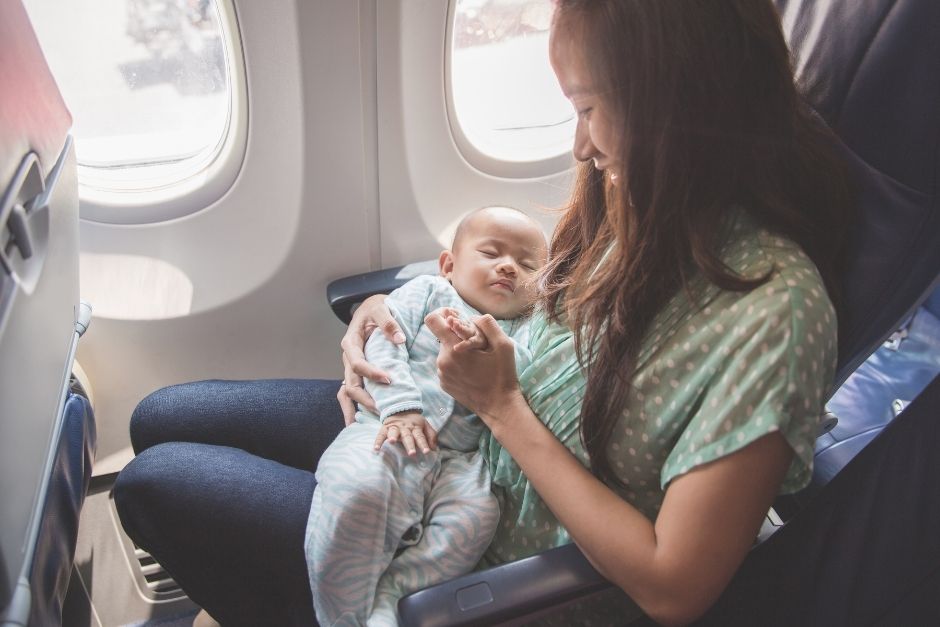 Woman holding a baby on an airplane
