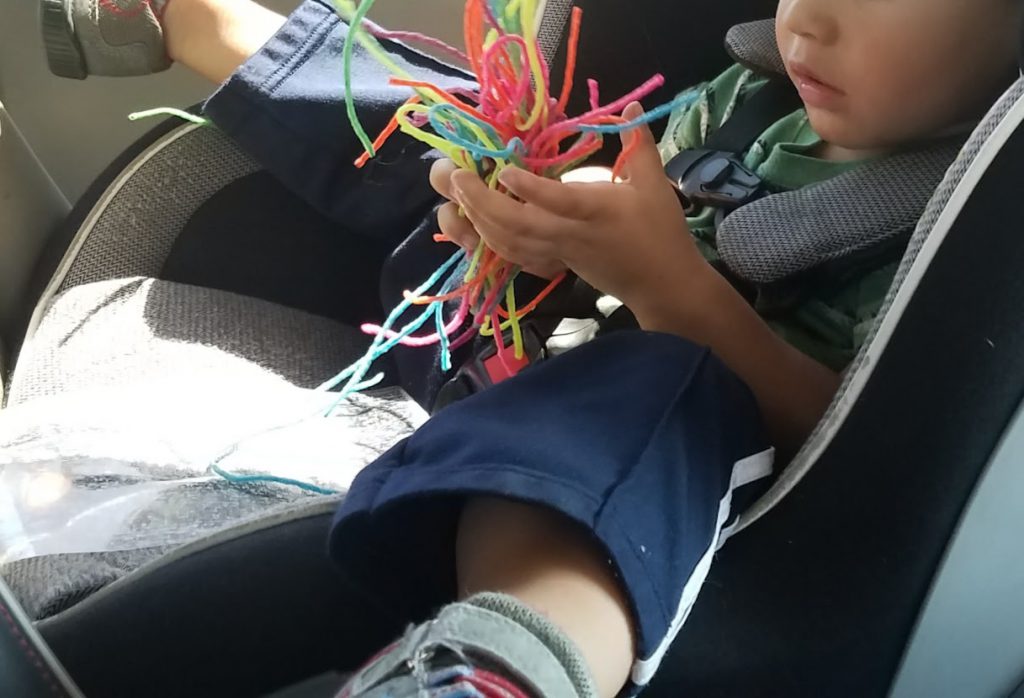 Toddler playing with a handful of Wiki Stix