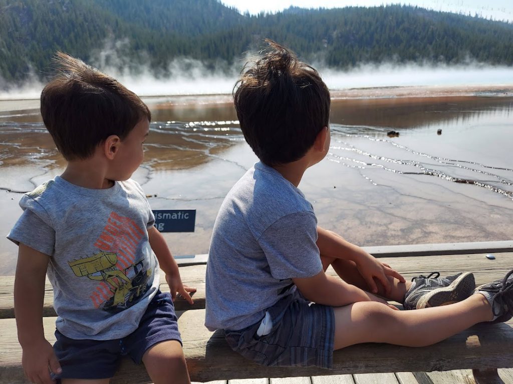 Kids looking out over Grand Prismatic Spring- 3 day Yellowstone itinerary