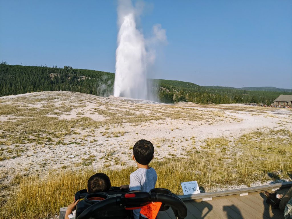 Children watching Old Faithful erupt