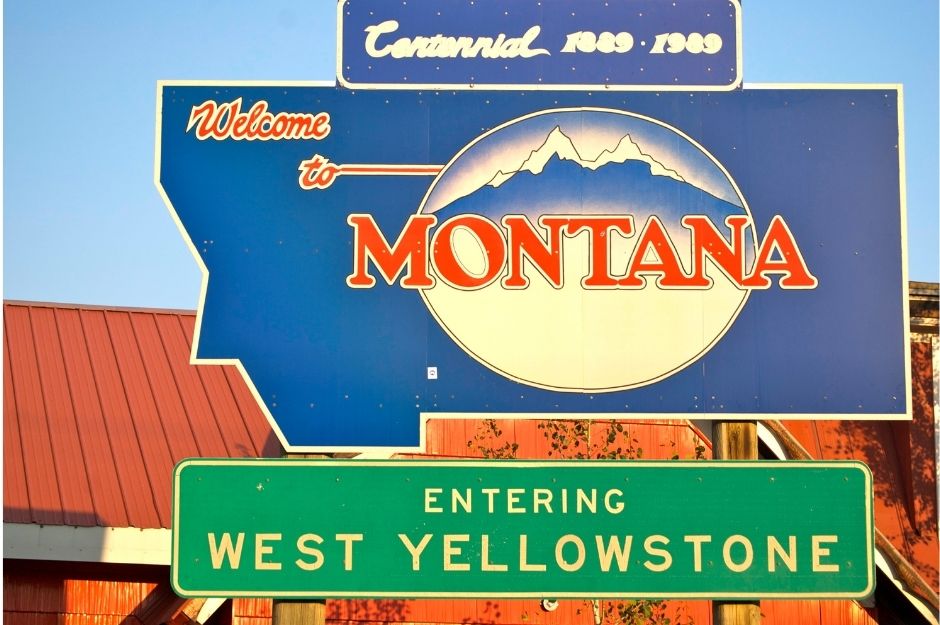 A sign that says "Welcome to Montana" and "Entering West Yellowstone"