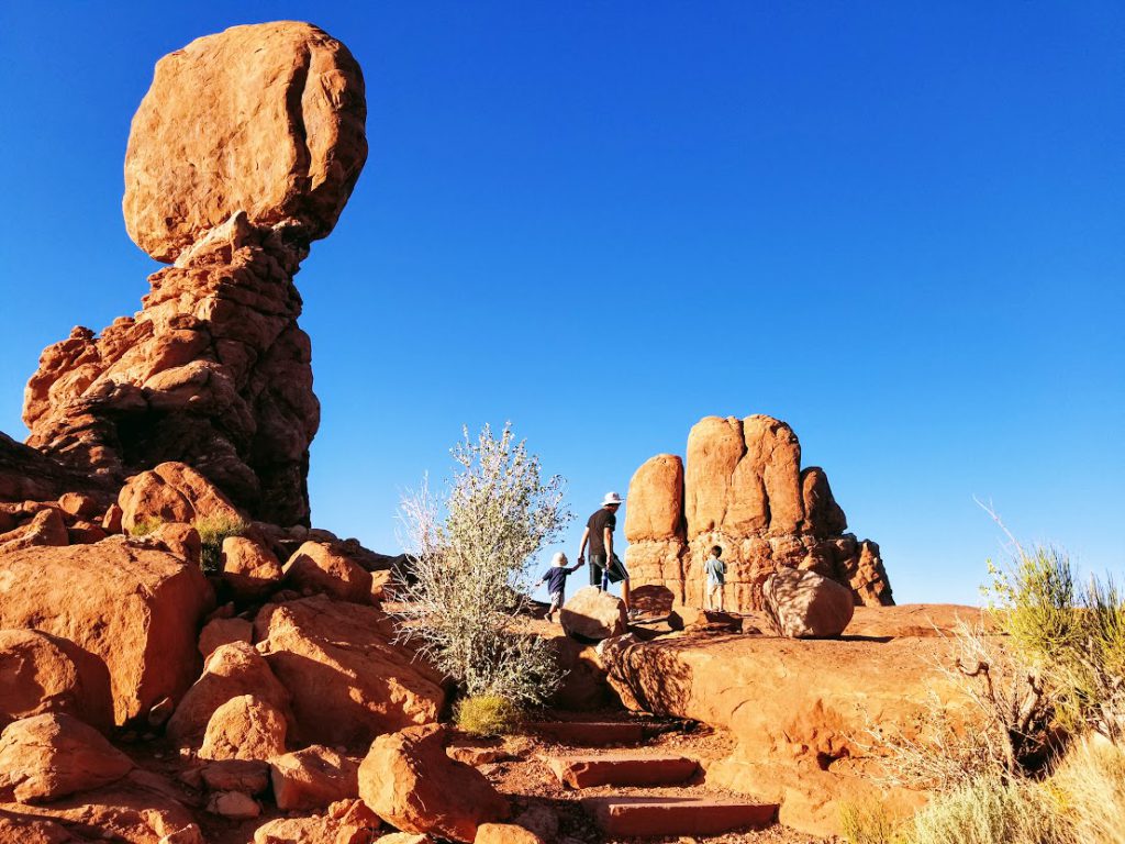 Family at Balanced Rock- Arches 
National Park with kids