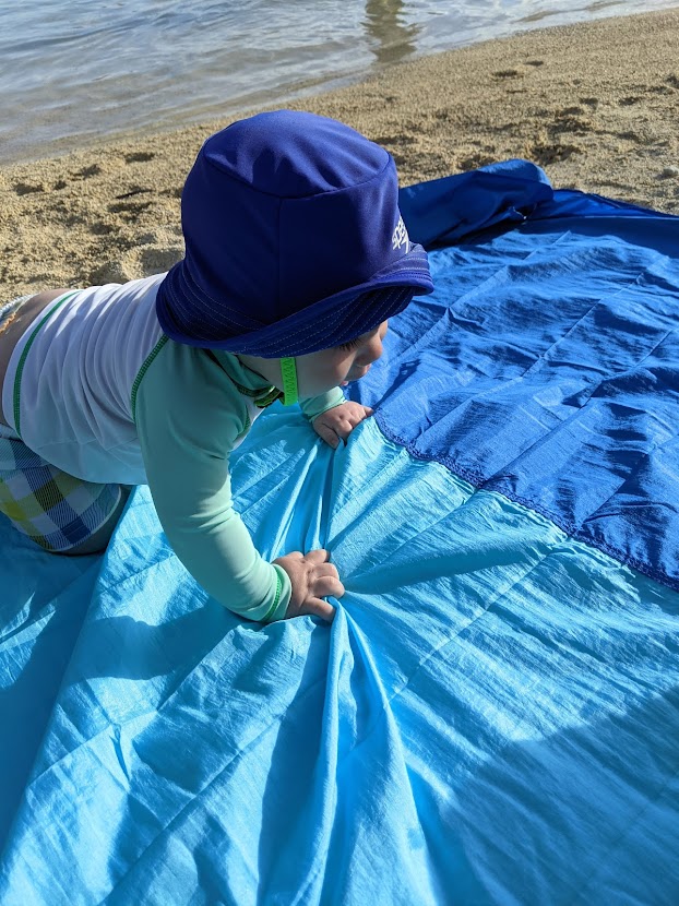 Baby on a beach blanket