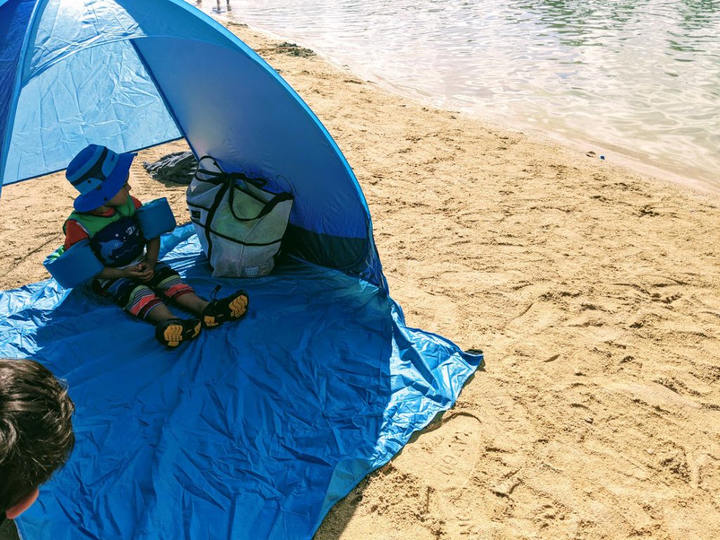 Child in a beach tent on the beach