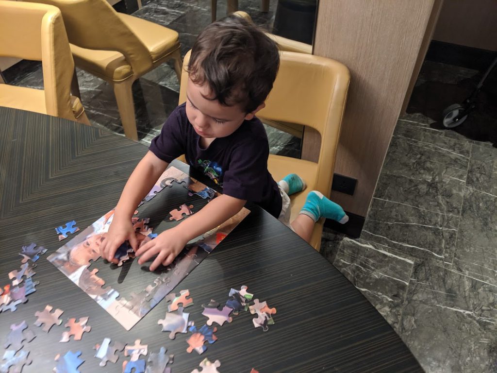 Child completing a puzzle in a hotel room