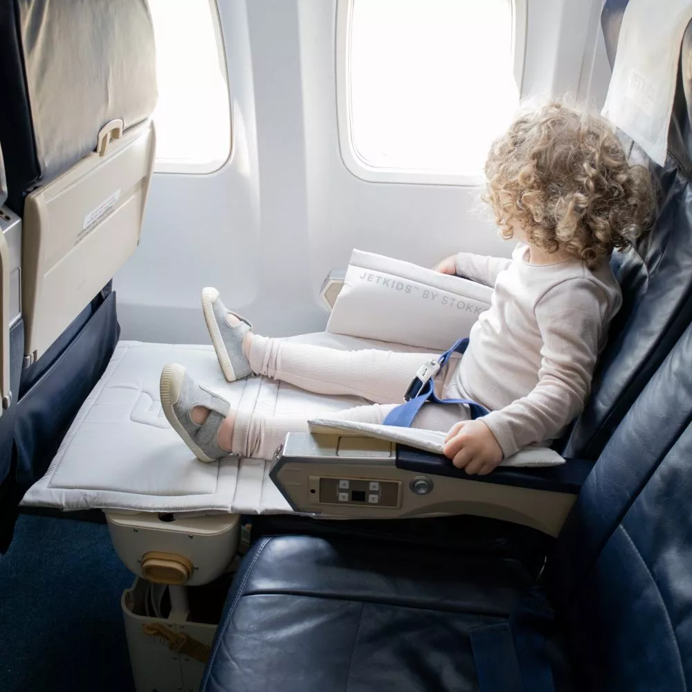 JetKids BedBox being used by a toddler on an airplane