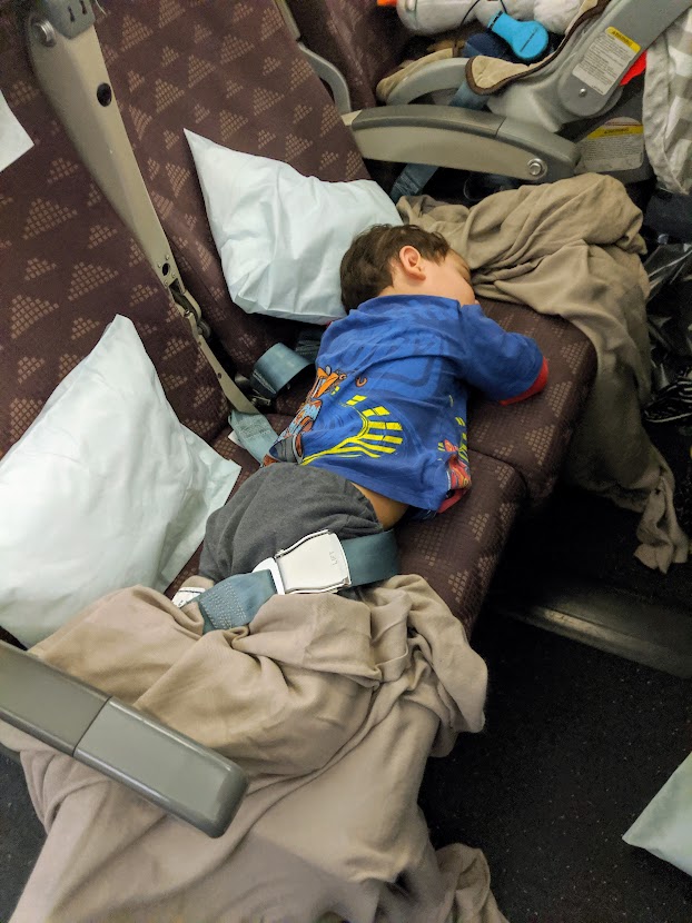 Child sleeping on an airplane seat