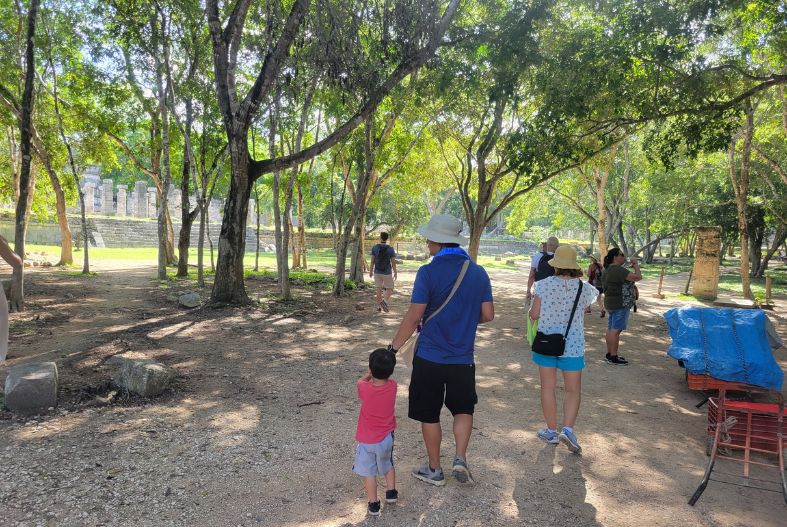 Family walking through Chichen Itza ruins