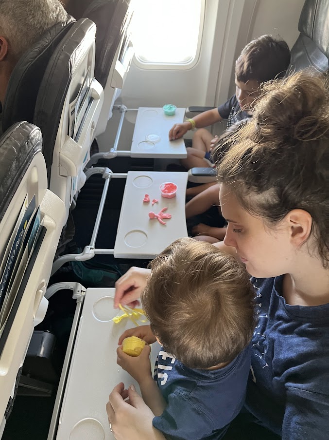 Kids playing with model magic on a plane