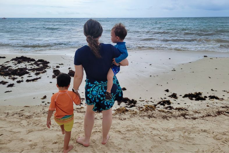 Woman with two kids on the beach in Playa del Carmen