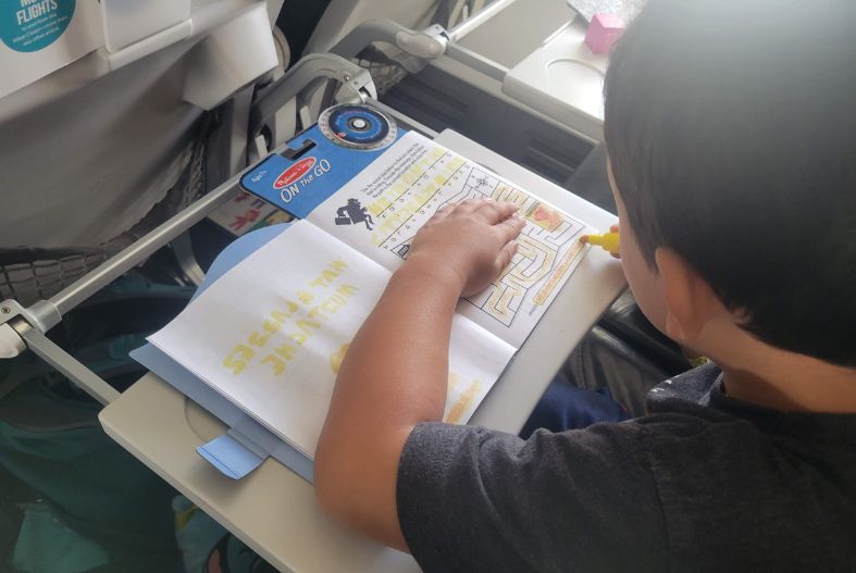 Boy completing the Secret Decoder activity book