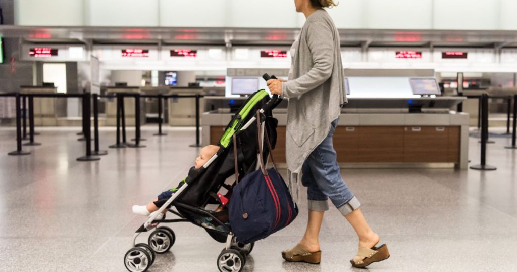 Woman pushing a stroller through the airport