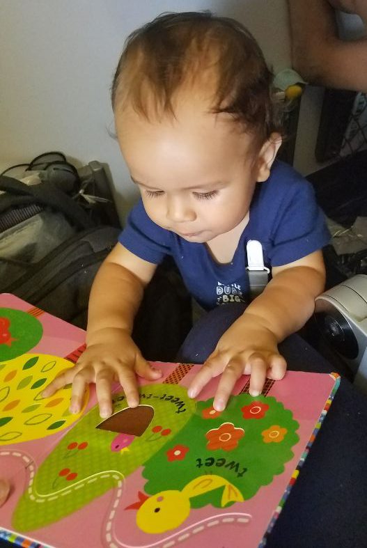 Baby with book on plane