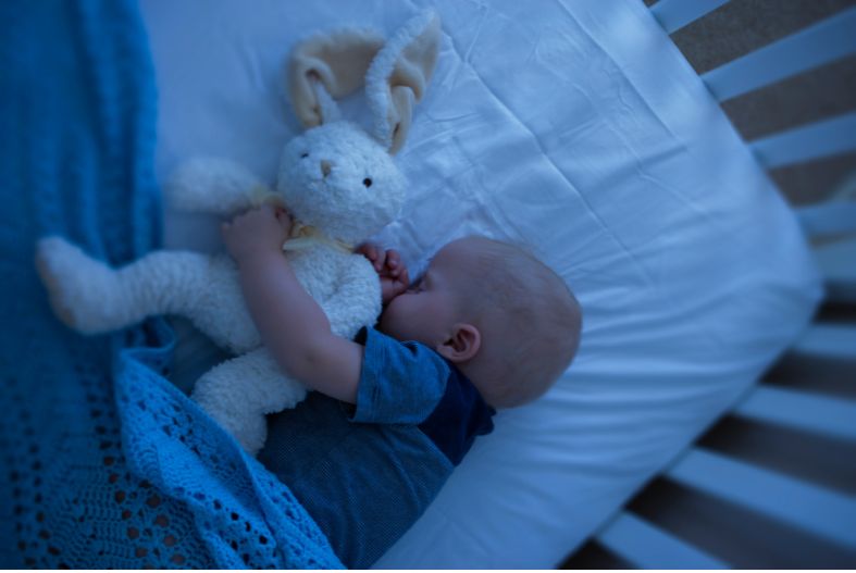 Baby sleeping with stuffy