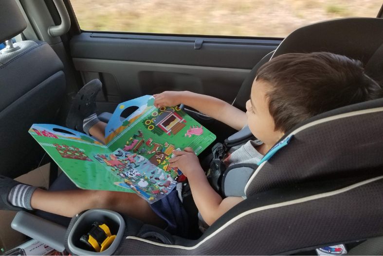 Toddler playing with a Melissa and Doug Puffy Sticker book