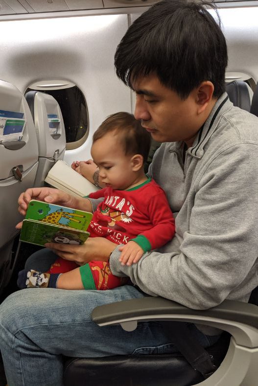 Toddler with book on plane