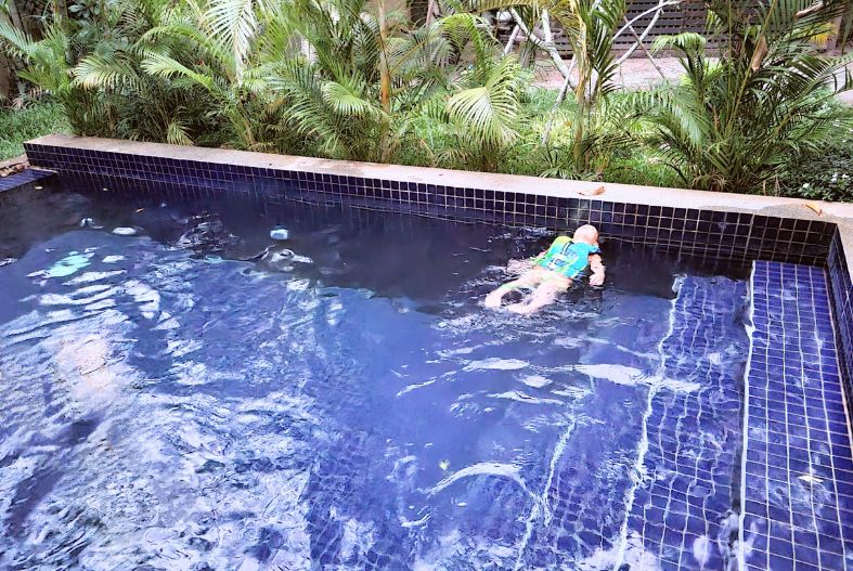 Child swimming in a pool in Siem Reap