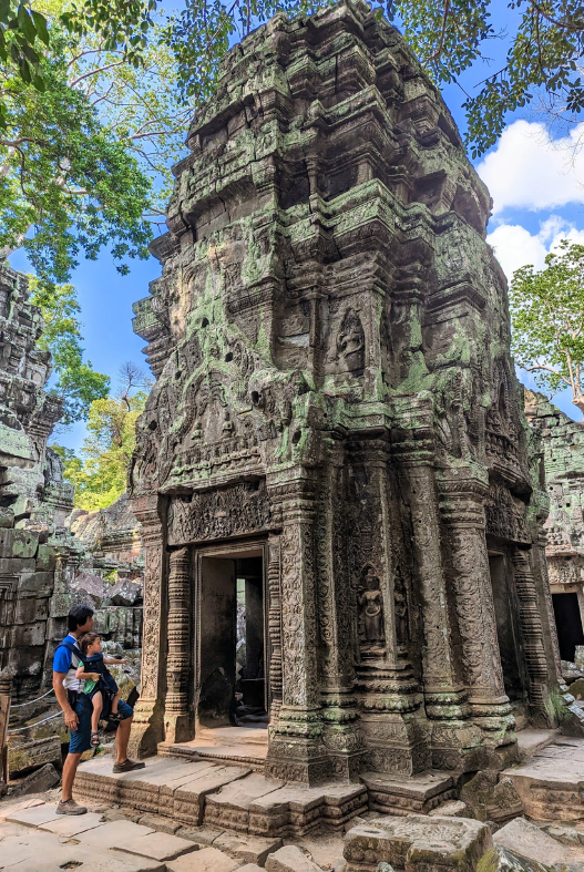 Man with a baby at Ta Prohm temple