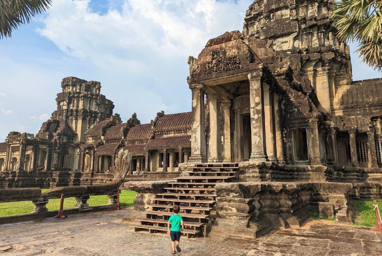 Child walking up the steps at Angkor Wat temple