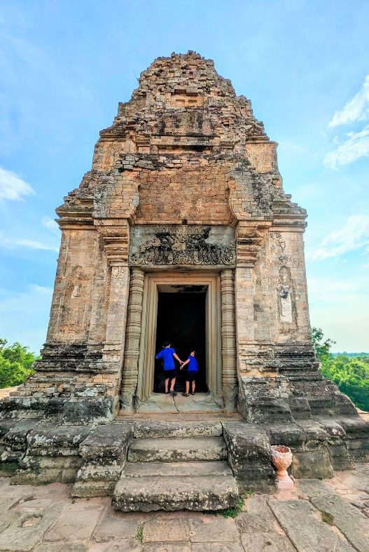 Children looking inside a temple at Pre Rup