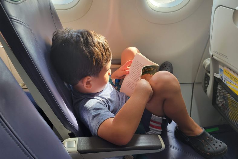 Child reading on an airplane