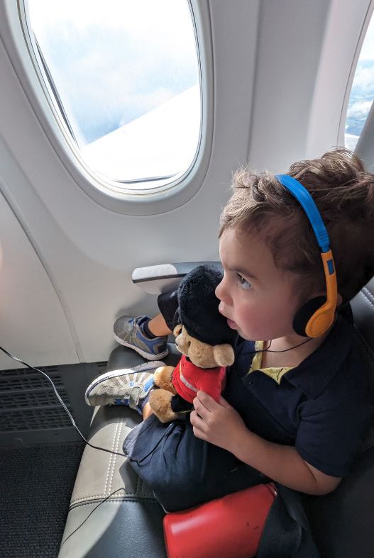 Toddler using headphones on the plane