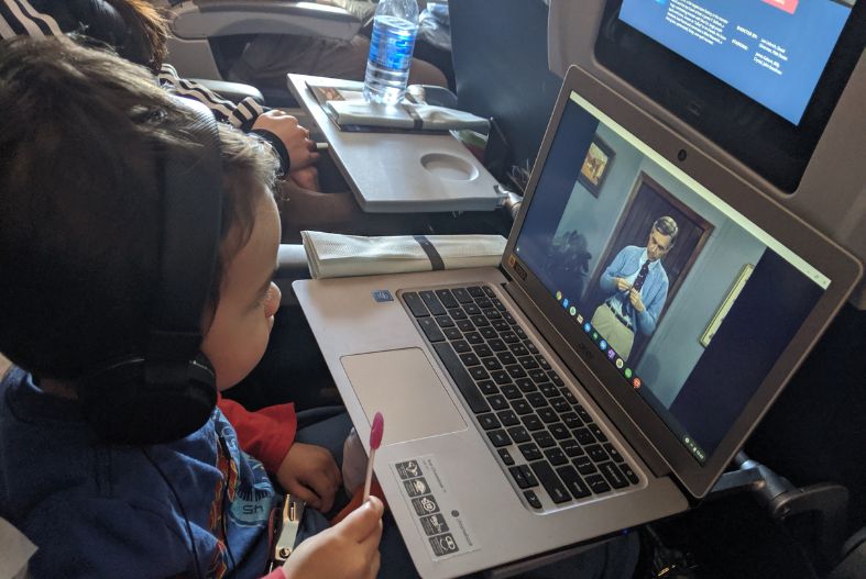 Toddler using headphones on the plane