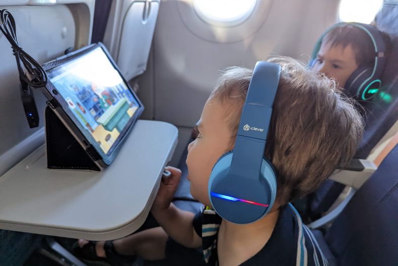 Children listening to headphones on the plane