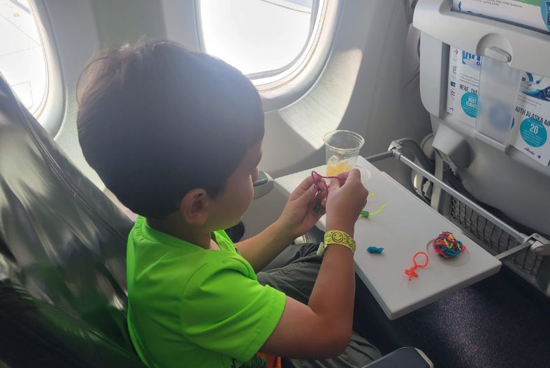 Child playing with Wikki Stix on the plane