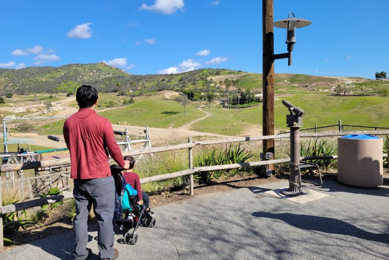 Man pushing child in stroller at San Diego Safari Park