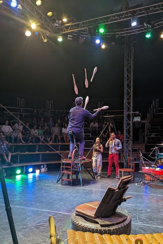 Man juggling on a unicycle on a tightrope