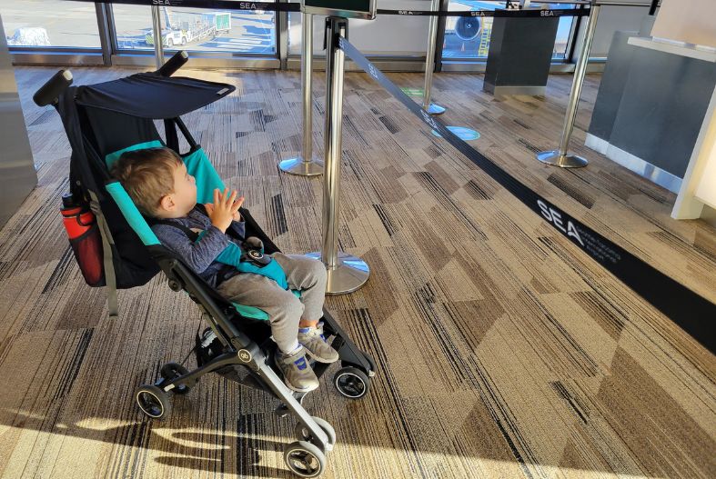 Child in a stroller at the airport gate